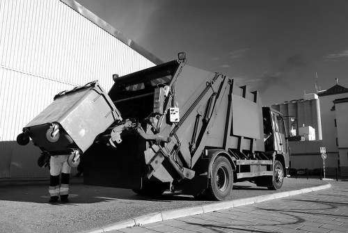 Operatives wearing PPE while loading a skip