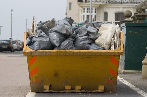 Skip hire vehicle and crew preparing for delivery
